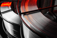 Close-up of coiled white and red cable on a black background